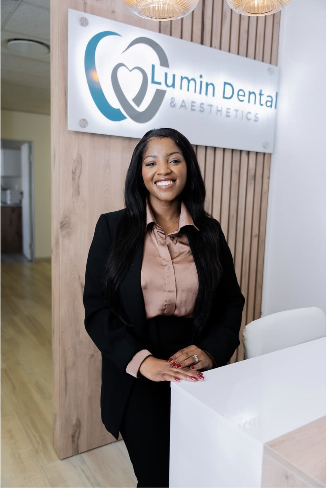 Dr Mapula Mashatola at the Lumin Dental & Aesthetics reception desk
