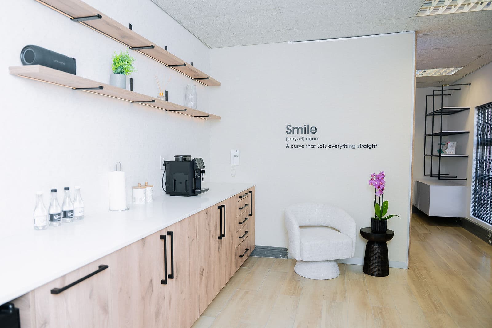 The studio bar with wooden shelving, products and coffee