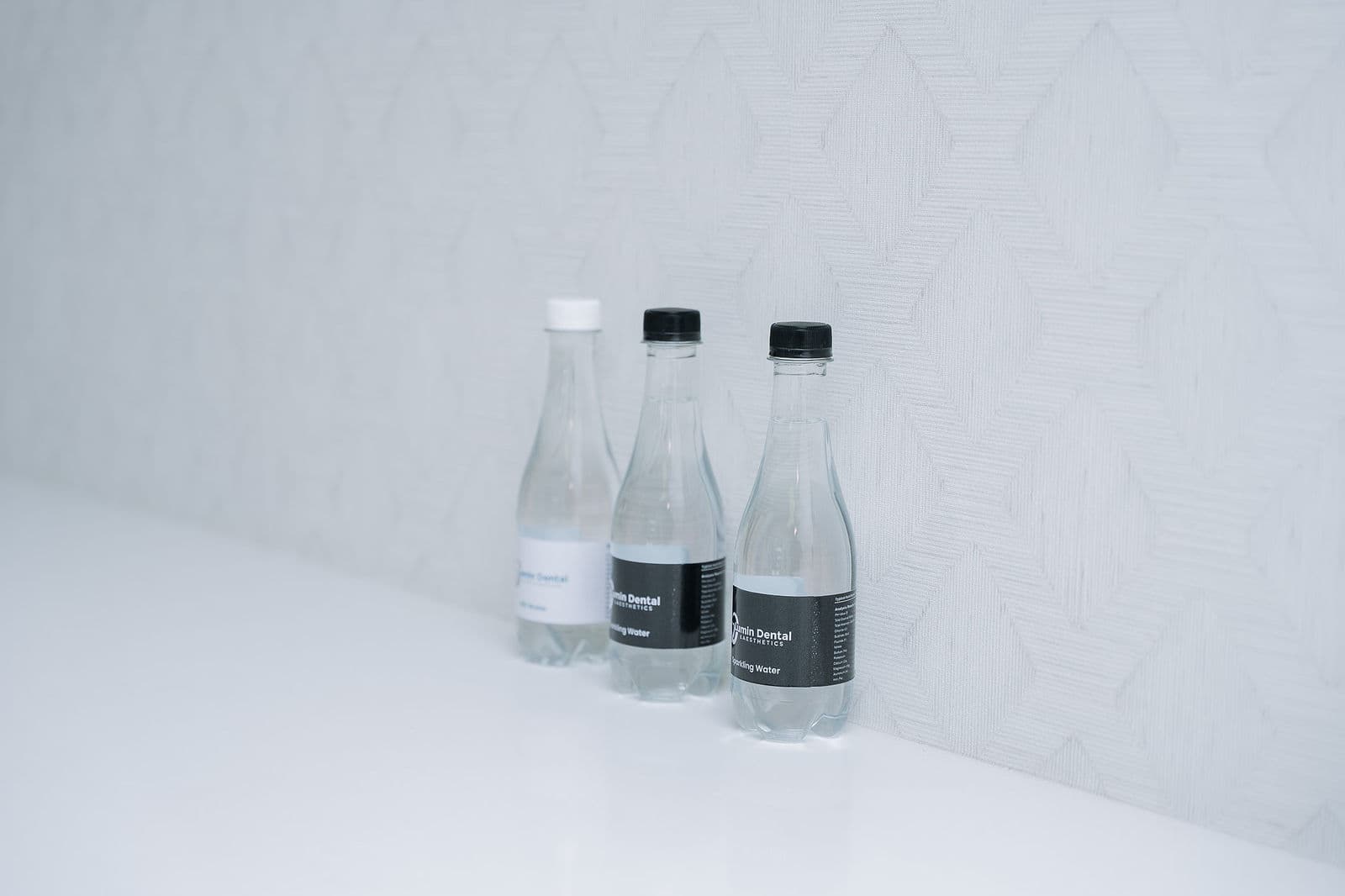 Lumin branded water bottles on the studio counter