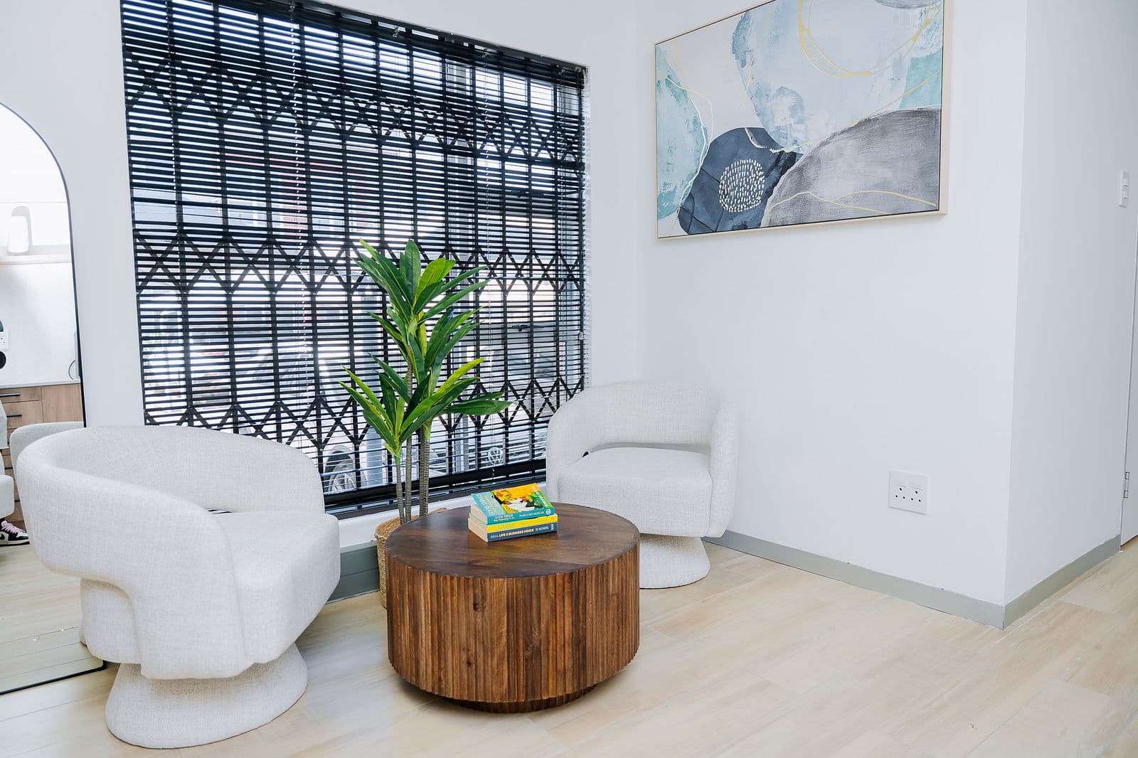 The lounge with soft armchairs, art and plants