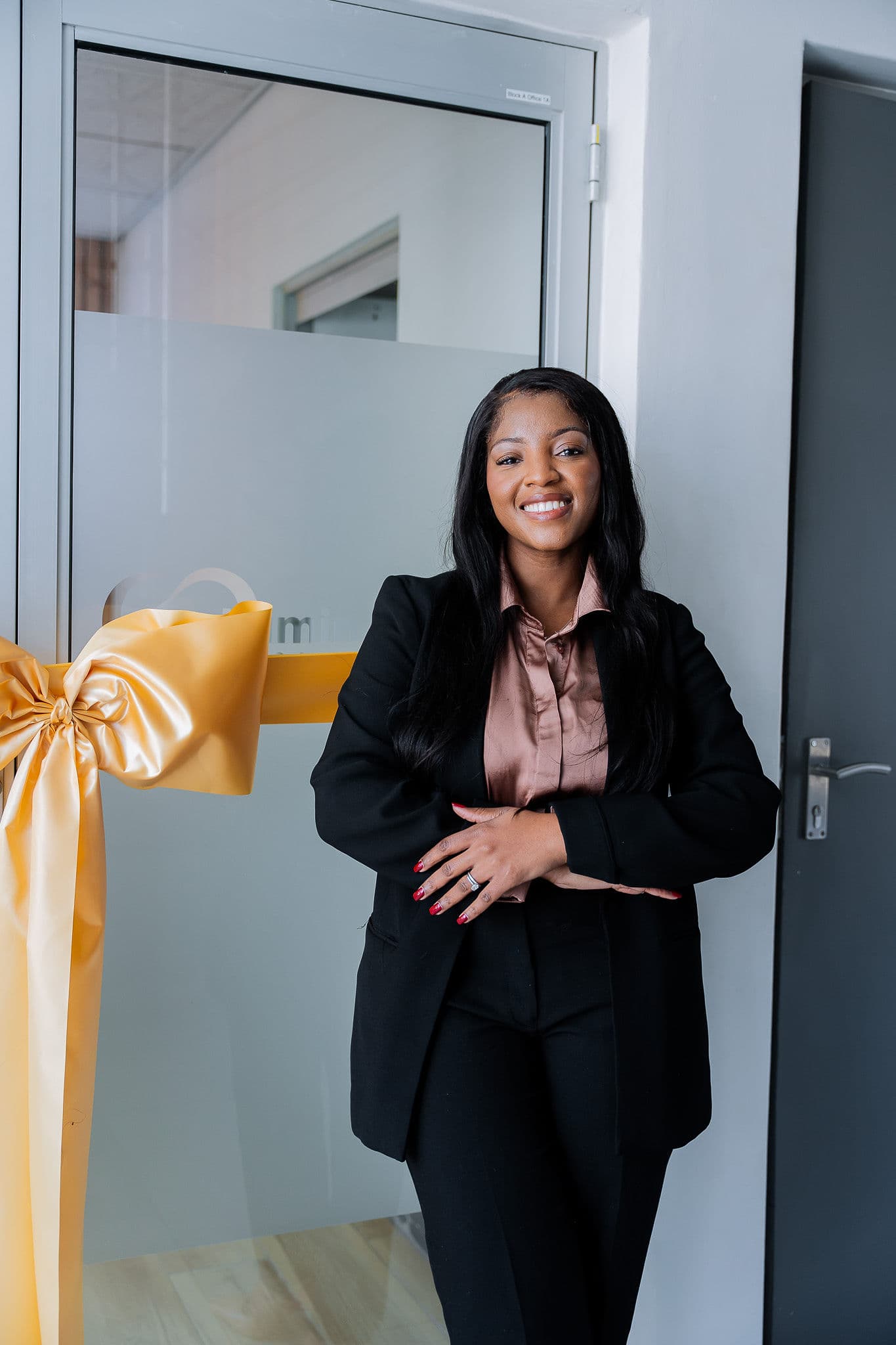 Dr Mapula Mashatola beside the gold ribbon at the Hartbeespoort studio opening